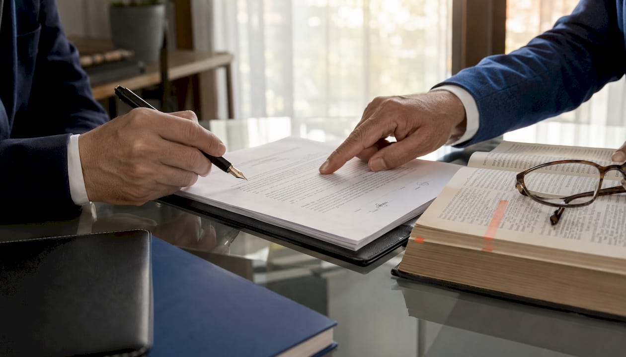 Hands exchanging co-ownership agreement documents