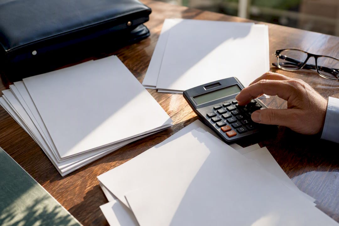 Calculator and tax forms on desk