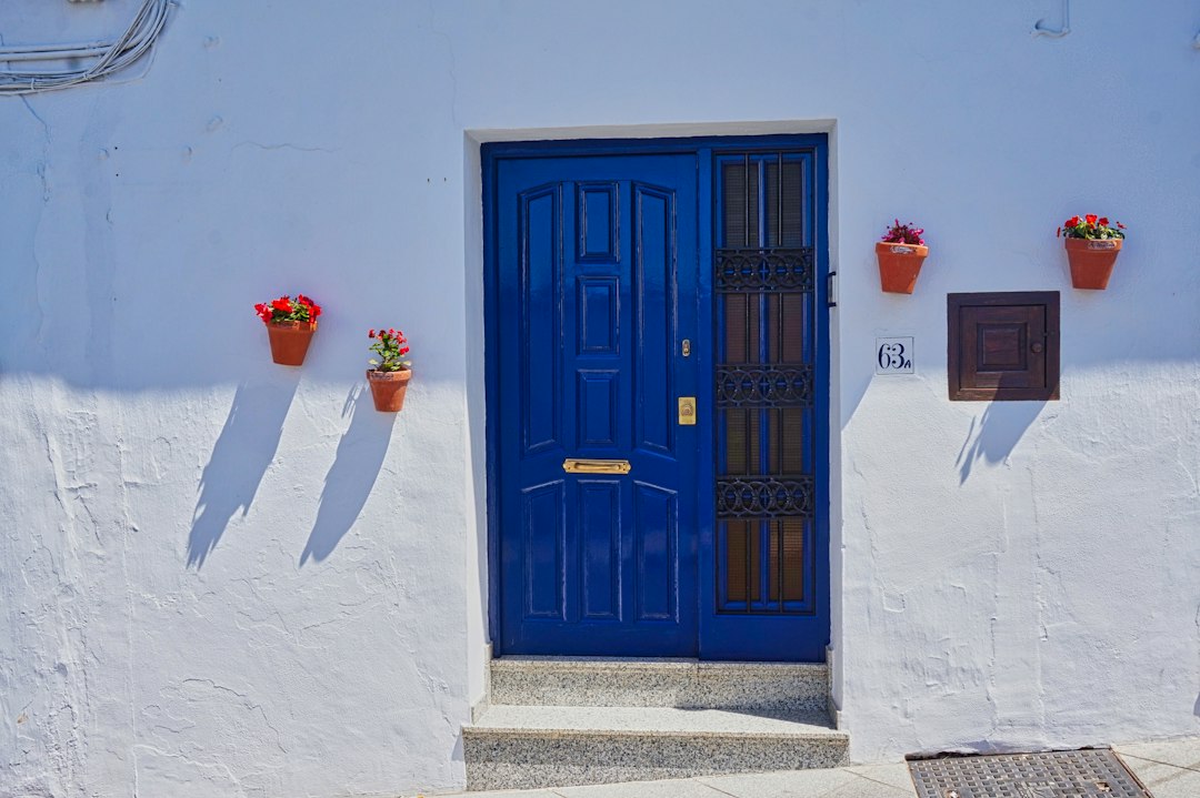 Blue front door of a whitewashed house in Frigiliana, Andalusia, illustrating a holiday rental entrance
