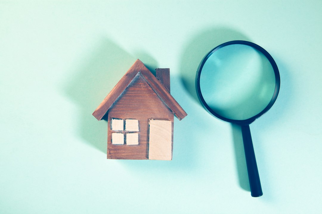 House model and magnifying glass representing property inspection and legal checks before buying